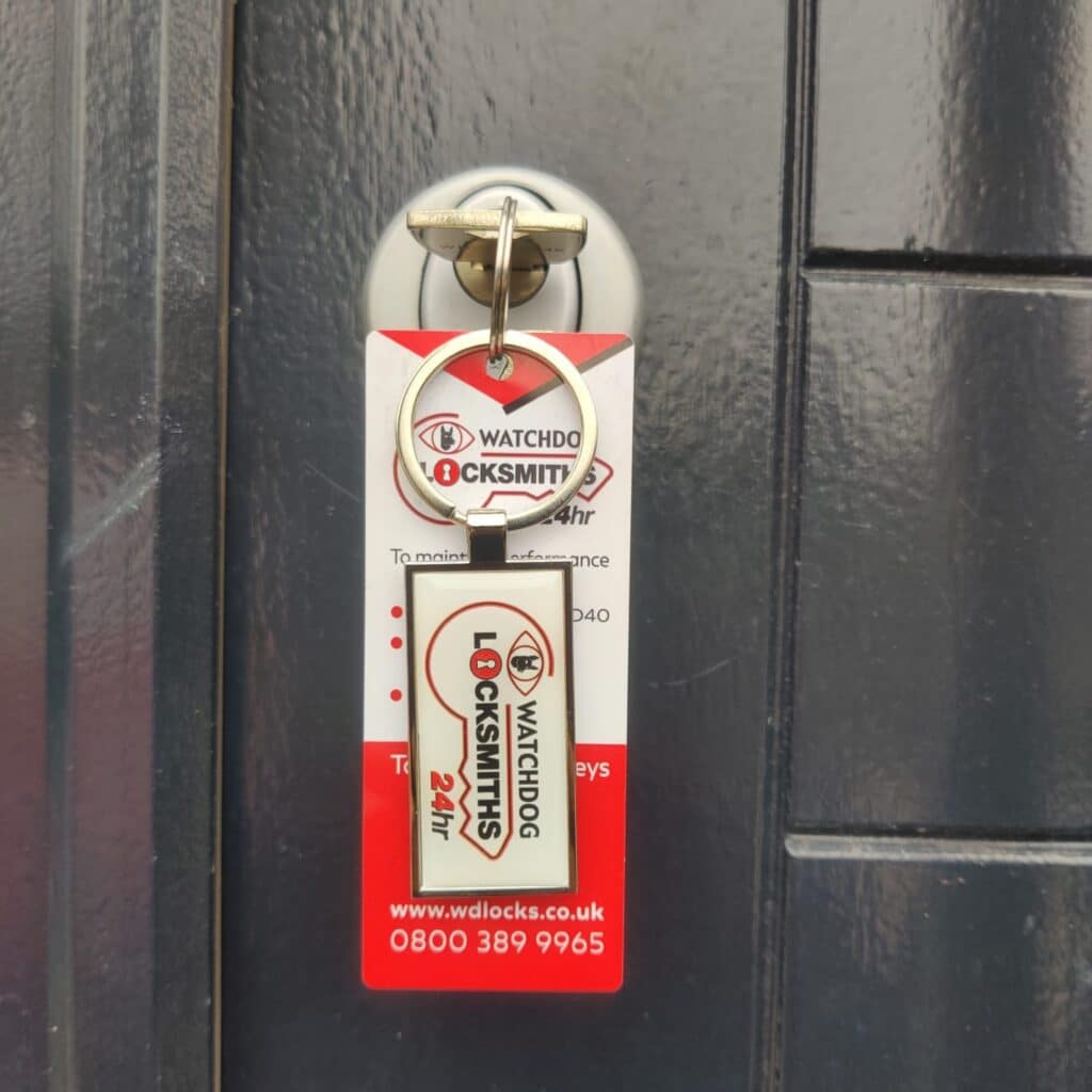 A watchdog locksmith key in a black door in Greenford